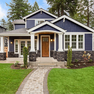 exterior blue and white residential home with stone walkway