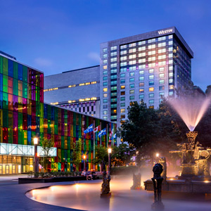 Exterior of the Westin Montreal hotel with illuminated windows.