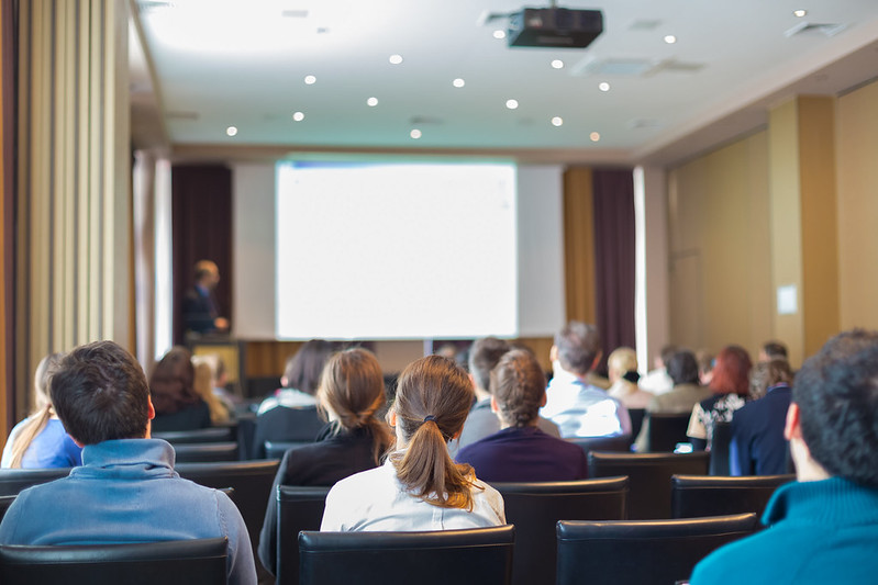 Photo of the back of people's heads at a conference