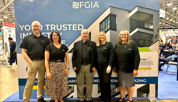 FGIA staff at GlassBuild America 2024 in front of the FGIA booth signage